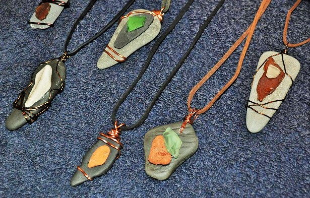 Wire Wrapped Beach Glass and Stone Pendants! These are made from beach glass, stone, brick, and pottery collected at Lake Cayuga, New York, this past summer. These pendants are on either suede or leather cord that can be tied behind the neck. 
Art Rains Jewelry